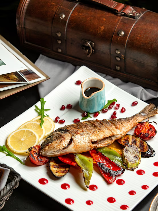 https://img.freepik.com/free-photo/dorado-grilled-dorado-with-tomato-eggplant-bell-pepper-zucchini-lemon-pomegranate-sauce-plate_140725-10924.jpg?semt=ais_hybrid&w=740