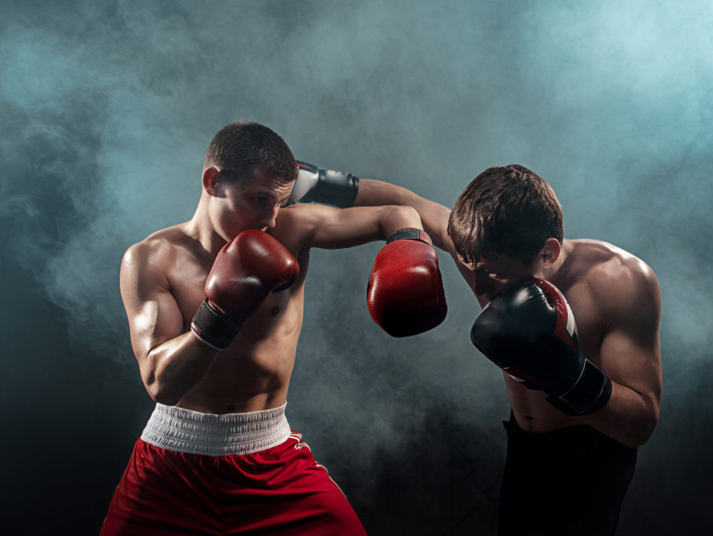    Two professional boxer boxing on black smoky studio background. redaktor