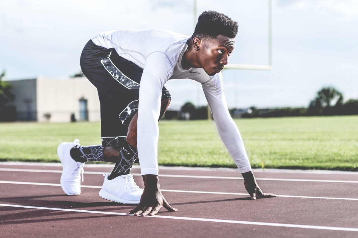 https://www.pexels.com/photo/man-wearing-white-sweater-and-black-shorts-about-to-run-936094/