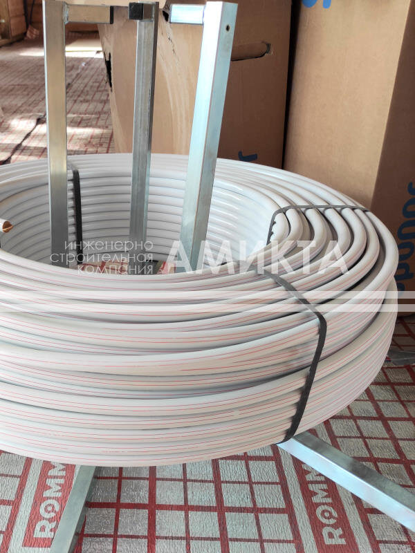 Установка бухты с трубой водяного теплого пола на размотчик. Фото с сайта https://amikta.ru/