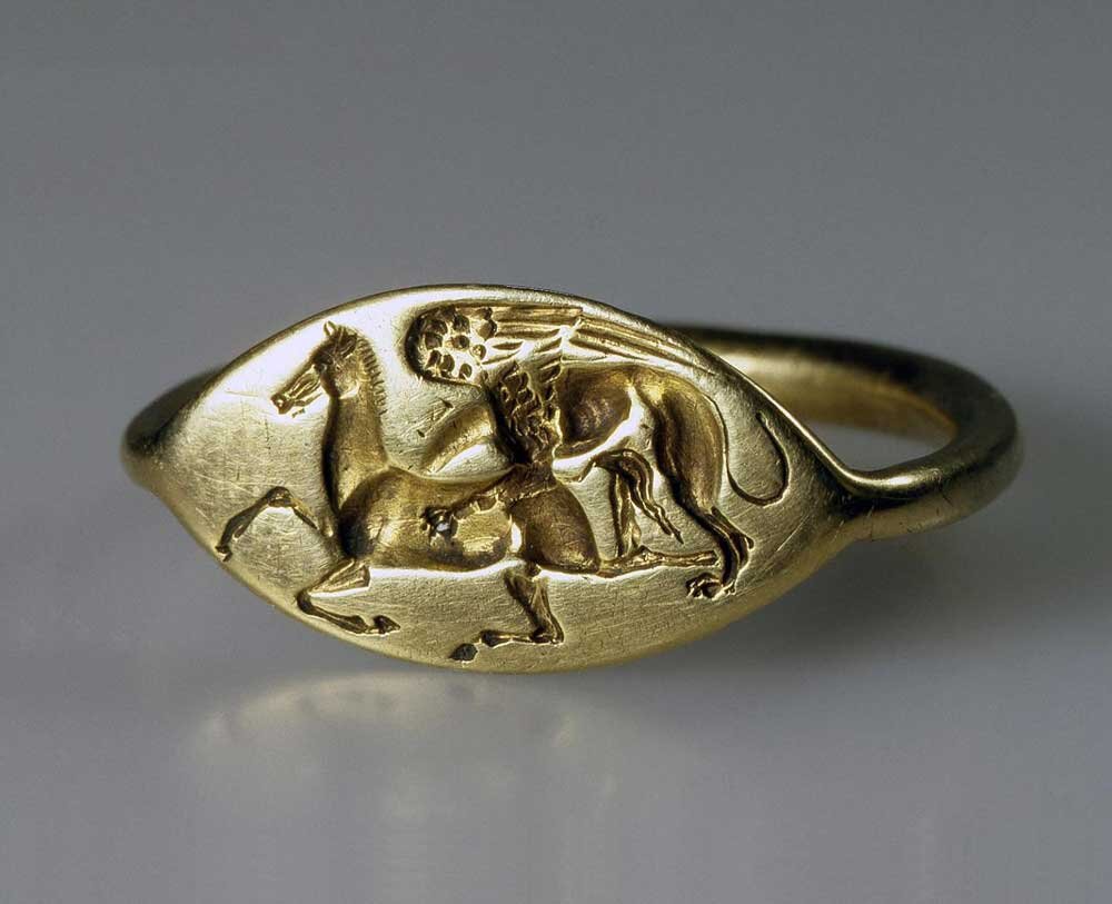 Золотой перстень 5 века до нашей эры с изображением грифона, который нападает на коня, найден в каменной гробнице Нимфеи в Крыму. Источник сайт Государственного Эрмитажа.