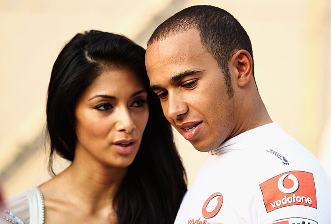 ABU DHABI, UNITED ARAB EMIRATES - NOVEMBER 14:  Lewis Hamilton of Great Britain and McLaren Mercedes and his girlfriend Nicole Scherzinger 