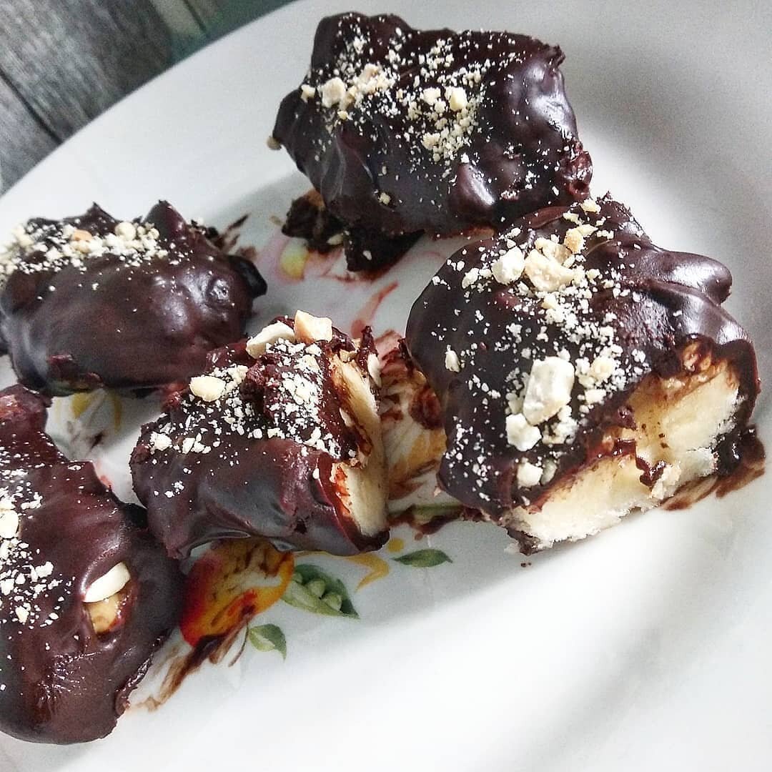 Ингридиенты: Бананы 2шт 
Арахисовая паста порционно 
Орехи кешью и арахис горсть 
Шоколад 1 плитка 
Приготовления: 
Бананы режем небольшими кусочками. На плоскую сторону банана намазать арахисовую пасту. Обваливаем этой стороной в дробленных орешках. Орехи прилипнут к пасте и купаем в шоколаде наши батончики. 
Отправляем в морозилку или холодильник до застывания. 