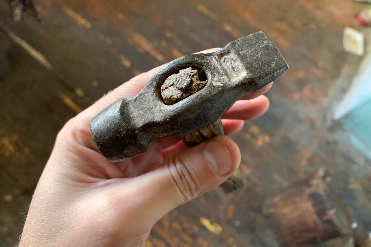 Молоток насажен на рукоятку при помощи гвоздя.