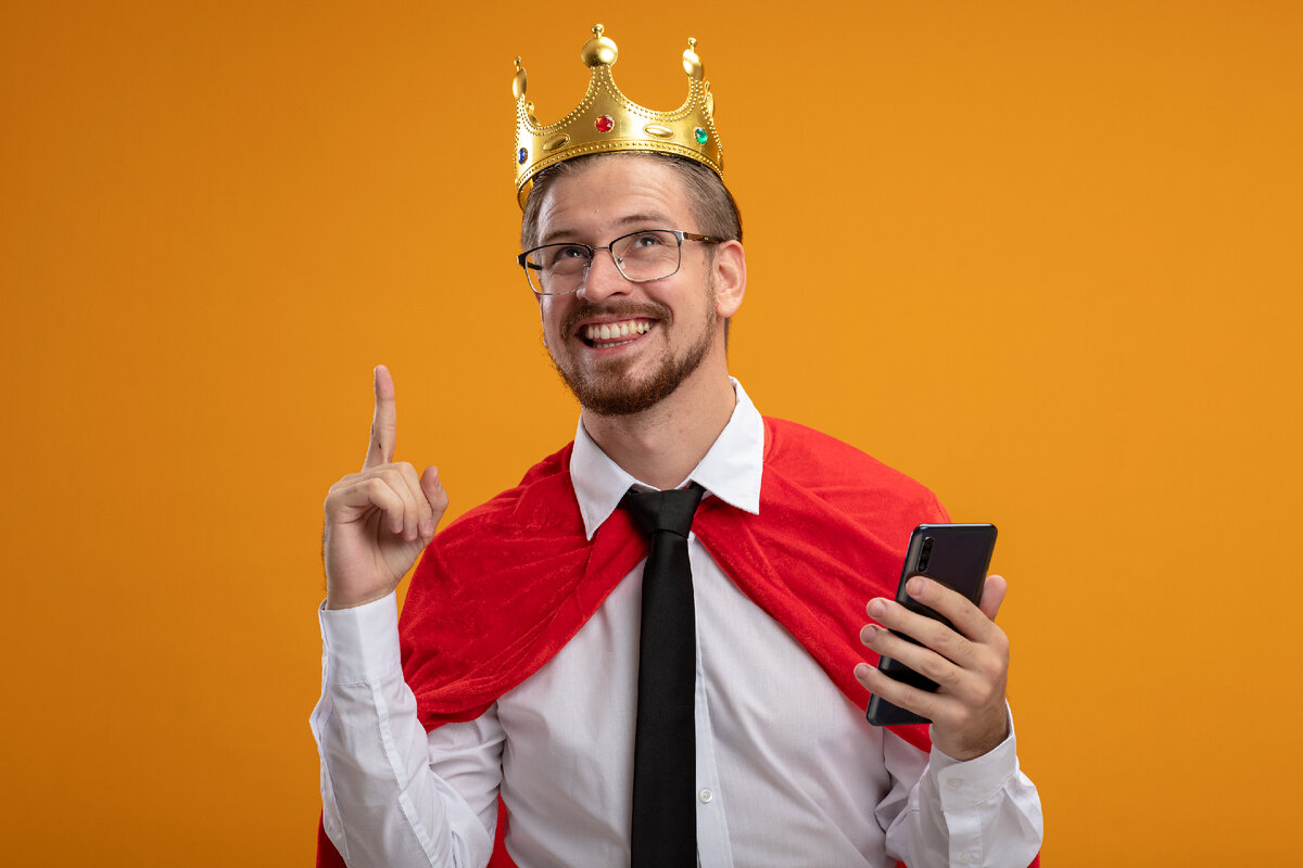 <a href="https://ru.freepik.com/free-photo/impressed-young-superhero-guy-wearing-tie-and-crown-with-glasses-holding-phone-and-points-at-up-isolated-on-orange-background_13536208.htm#query=%D0%BC%D1%83%D0%B6%D1%87%D0%B8%D0%BD%D0%B0%20%D1%81%20%D0%BA%D0%BE%D1%80%D0%BE%D0%BD%D0%BE%D0%B9&position=0&from_view=search&track=ais">Изображение от stockking</a> на Freepik