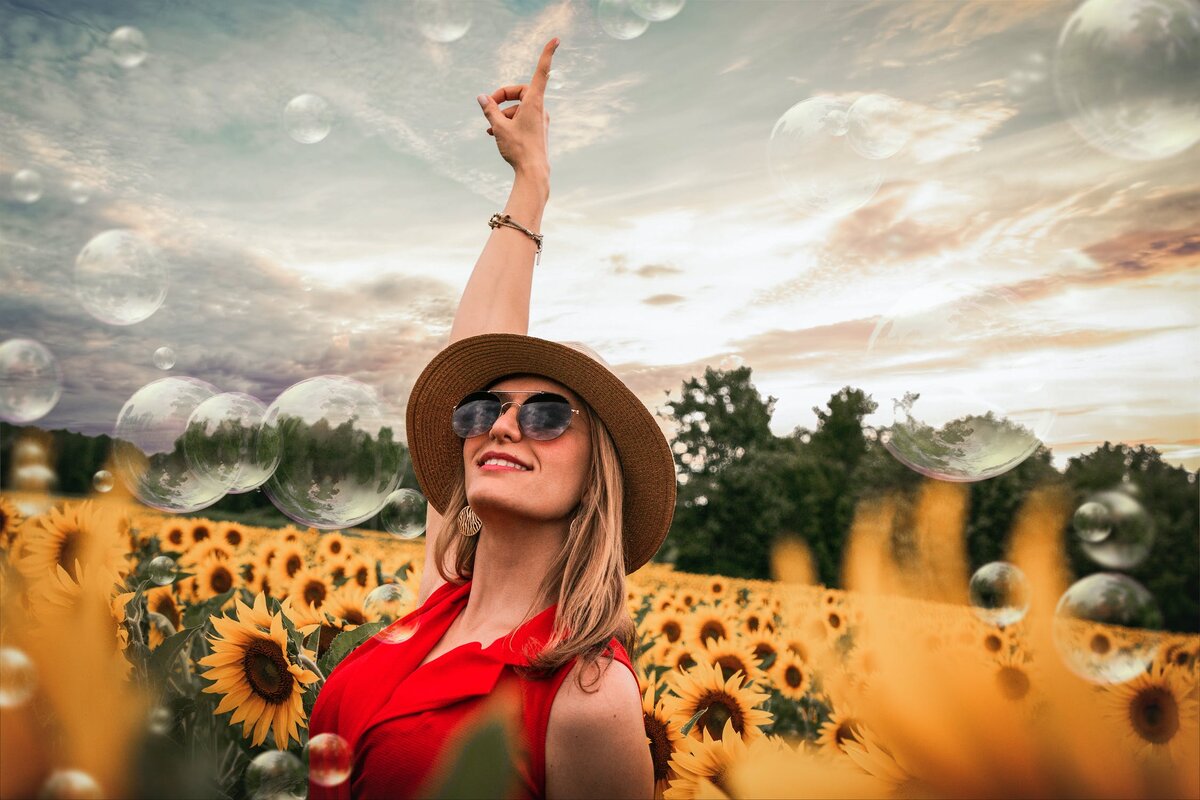 https://www.pexels.com/photo/woman-surrounded-by-sunflowers-raising-hand-1261459/