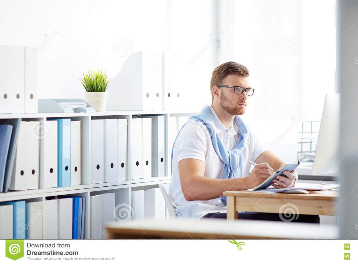 Фото взято из источника: https://www.dreamstime.com/stock-photo-young-specialist-office-making-notes-writing-working-plan-image75850674