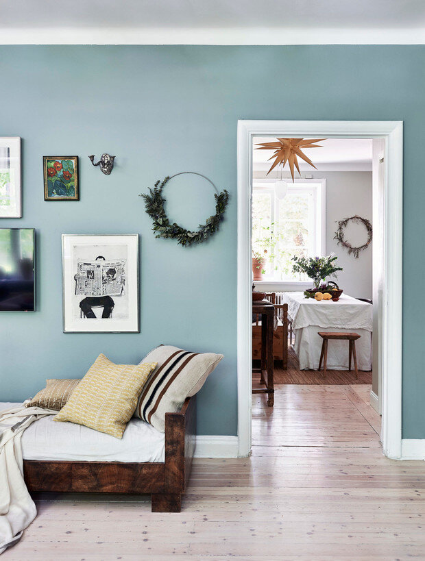 Кушетка по дизайну Акселя Эйнара Хьорта была куплена практически за бесценок и является лучшим приобретением Софии и Андреаса, любимое место всей семьи. Подушки, Dragonfly Yellow и Offwhite / Natural, Mimou. Полосатая подушка, Libeco / GAD. Черно-белая картина на стене — автопортрет австралийского художника Адриана Пейджа. Она была подарена матери Софии, когда она собиралась переехать из Австралии в Швецию. Оловянный подсвечник на стене куплен в Mostrarnas Diversehandel в Энскеде. ФОТО ДЖЕЙМС СТОКС