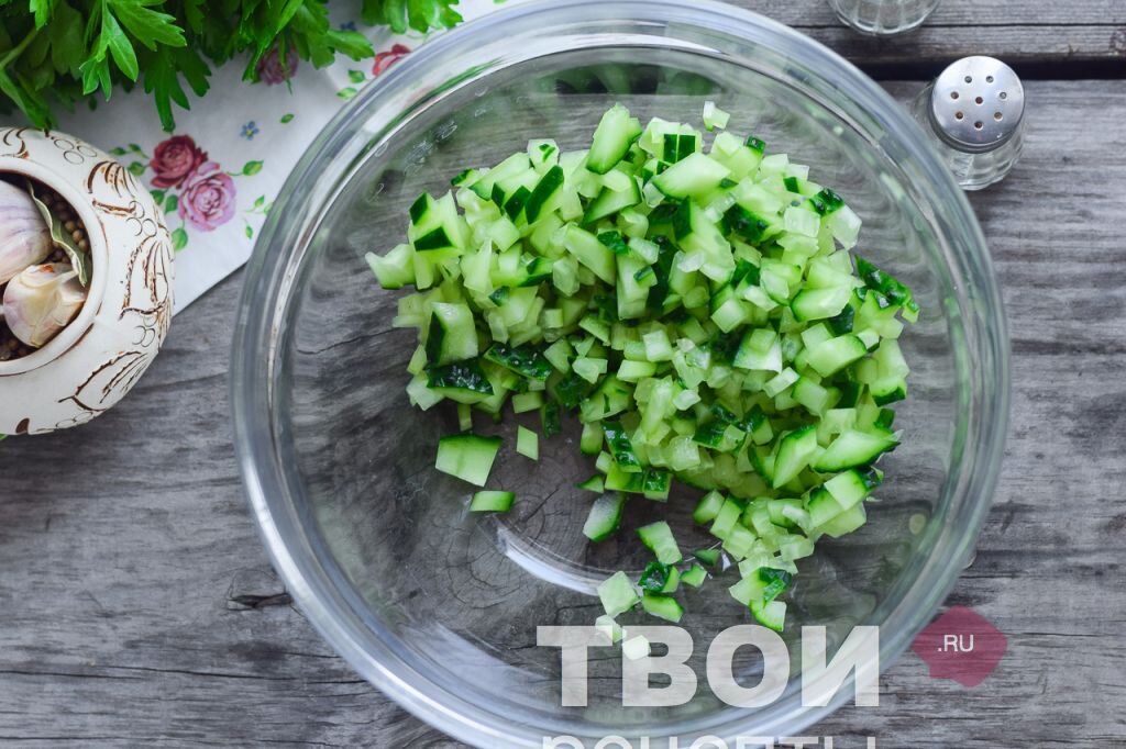 1 - Сладкие салатные огурцы вымыть, просушить. Обрезать хвостики у огурцов с обеих сторон, после нарезать огурцы мелкими кубиками. Сложить огуречную нарезку в глубокую миску. 