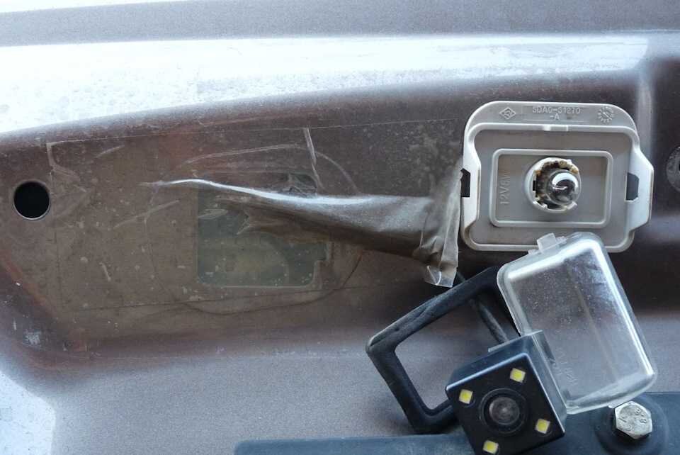 Кабель заходит через мембрану, которую проткнули отверткой и заклеили обратно обычным скотчем. Мммм, супер-решение. Попутно видим, что лампочки подсветки номера плавят контакты.