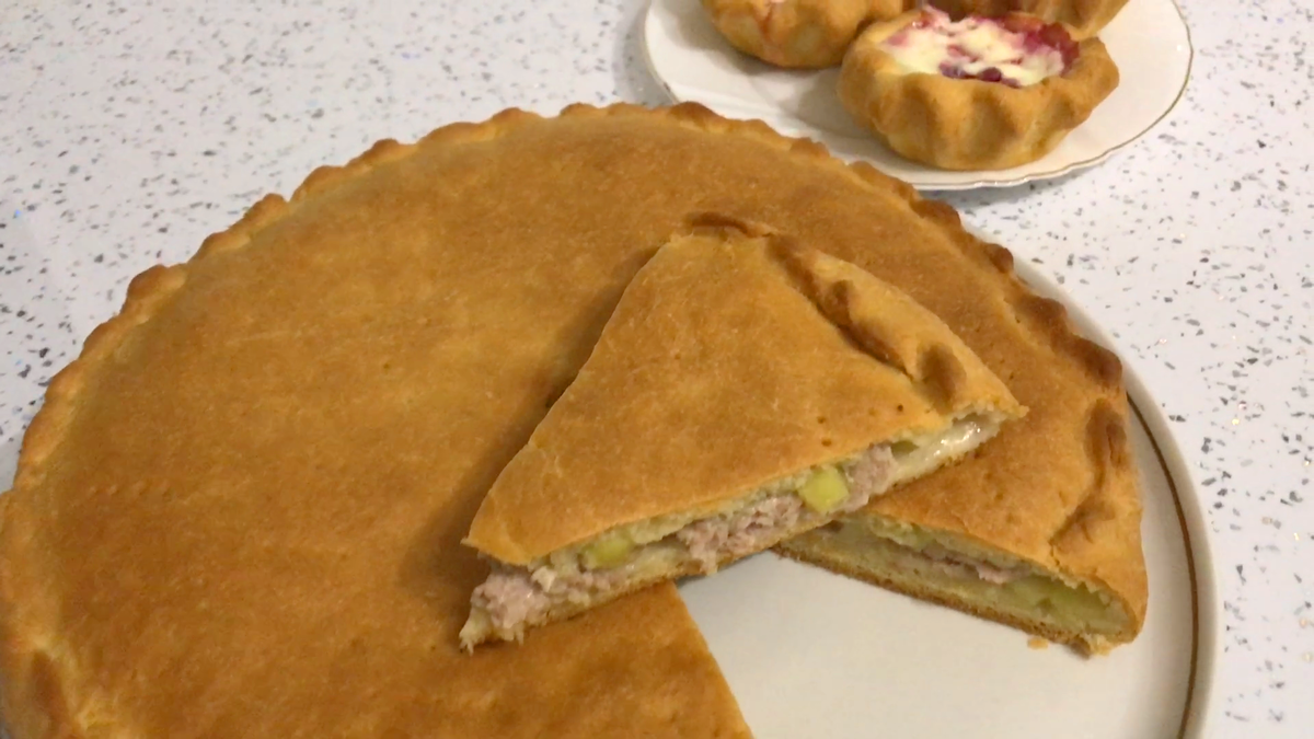 Meat pie and sweet tartlets with lingonberries from butter pastry for tea
