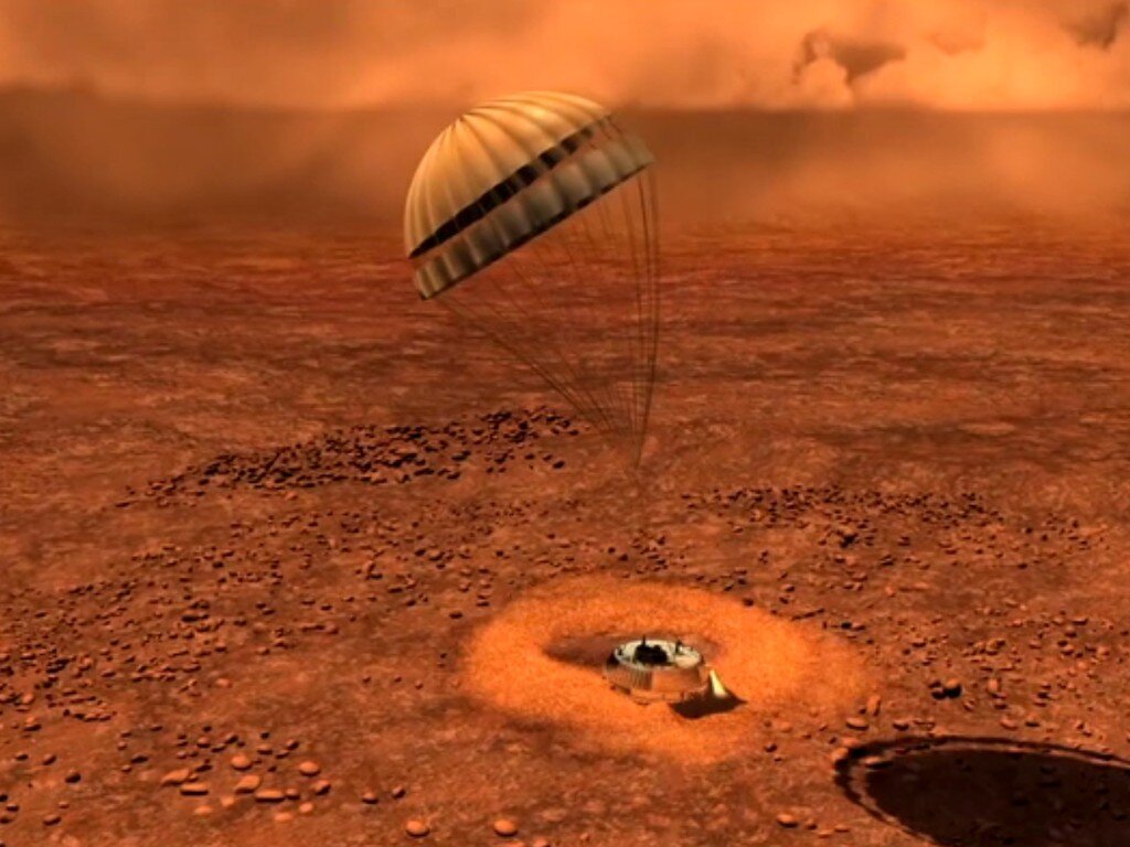 На какой планете самые сильные ветра. Титан Спутник Сатурна Гюйгенс. Зонд Гюйгенс на Титане. Поверхность спутника титана Гюйгенс. Зонд Гюйгенс на Титане спуск.