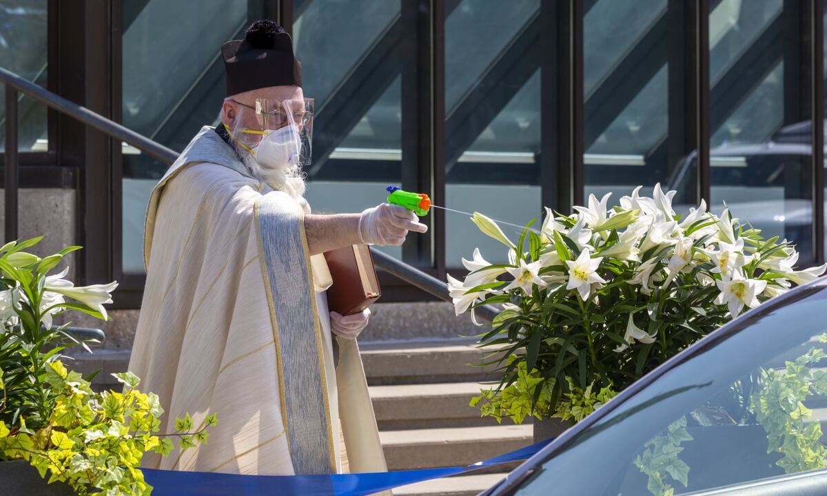 from The Guardian- Timothy Pelc conducts the traditional Blessing of the Easter Baskets at St Ambrose Catholic church in April. Photograph: Jim West/Zuma Wire/Rex/Shutterstock