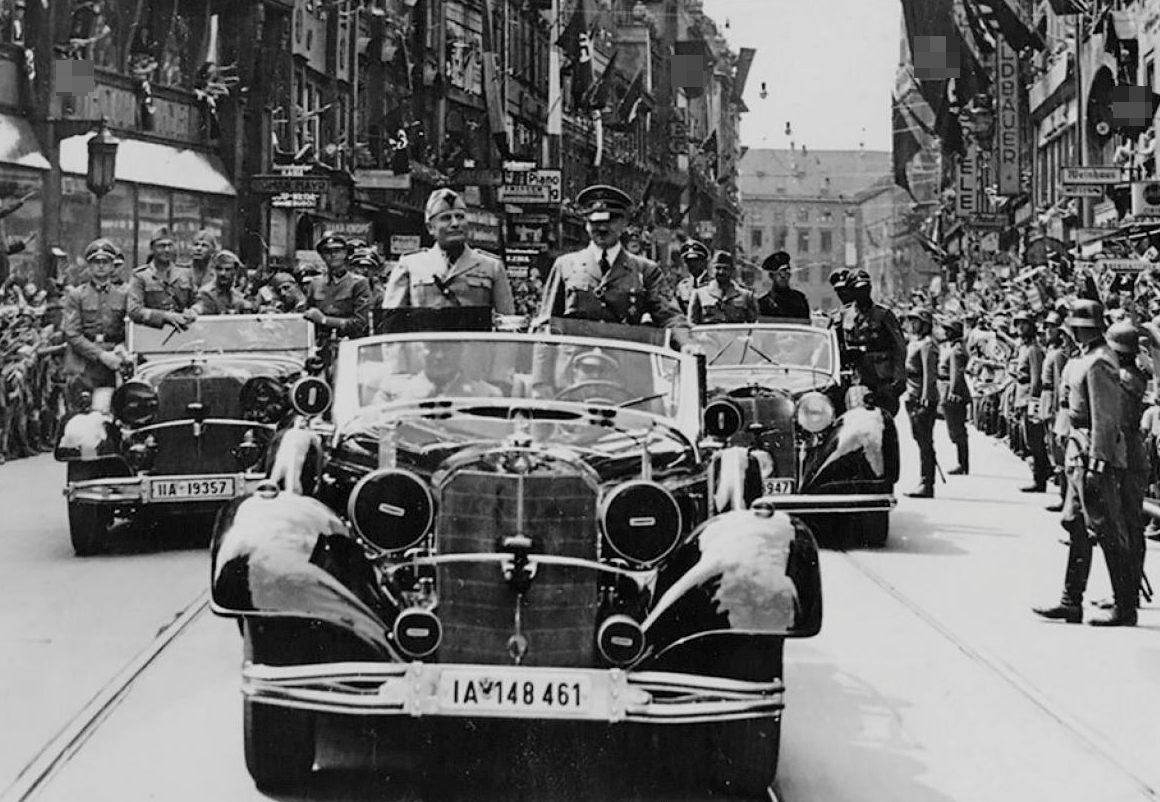 Адольф Гитлер и Бенито Муссолини едут в кабриолете Mercedes-Benz 770K Grosser Offener Tourenwagen по улице Мюнхена, июнь 1940 года