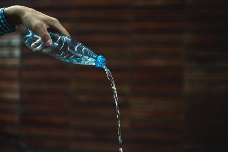 https://st4.depositphotos.com/15109688/31268/i/1600/depositphotos_312689536-stock-photo-hand-holding-plastic-bottle-pouring.jpg