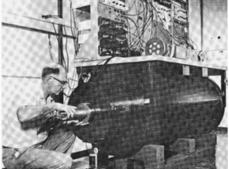 Для защиты от внешнего фона пропорциональные счетчики помещались в гильзы от корабельных снарядов. На этом фото Дэвис помещает счетчик в гильзу. Источник фото: "Острые грани", весна 1969.