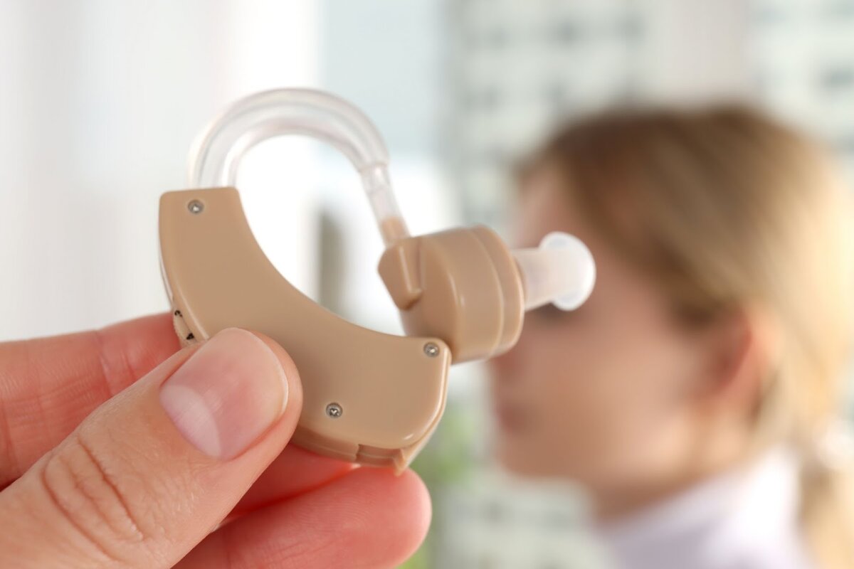 Perfect hearing. Excellent hearing. Ребенок со слуховым аппаратом играет. Putting hearing AIDS.