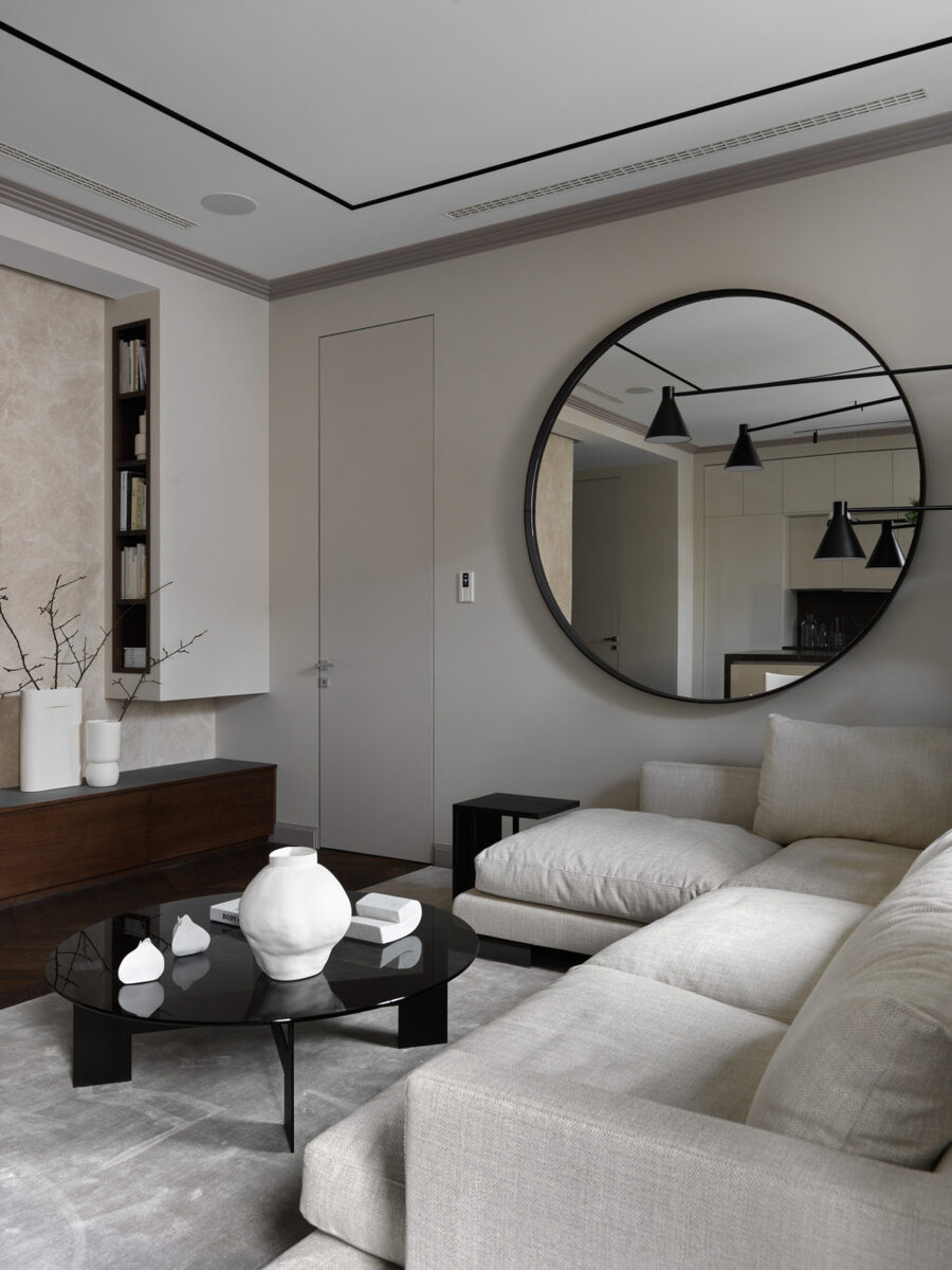  Фрагмент гостиной. Диван, Flexform; журнальный столик, Minotti; кофейный столик, Flexform; светильник, De Padova; зеркало, Meridiani; ковер Emotion, Carpetlinq; на журнальном столике скульптура из мрамора Елены Артеменко; двери скрытого монтажа, “Триумфальная марка”.