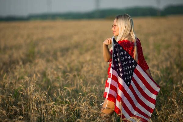 Блондиночка - a blondie. Источник изображения: https://ru.depositphotos.com/403787972/stock-photo-beautiful-young-woman-red-dress.html