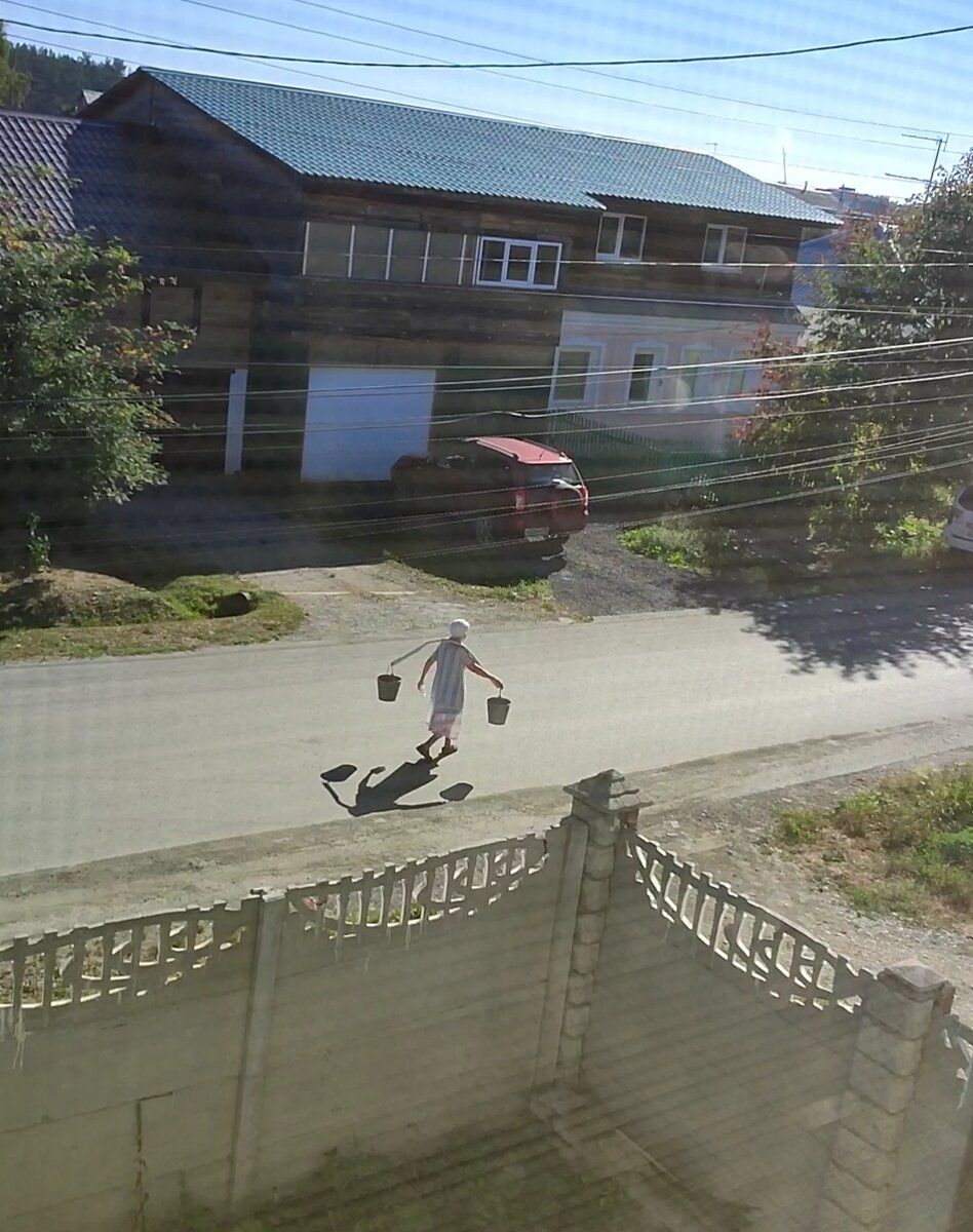 Эта бабушка каждое утро проходит под нашими окнами с коромыслом и вëдрами, очень бодренько идëт ещё и напевает. Вот это счастье. 