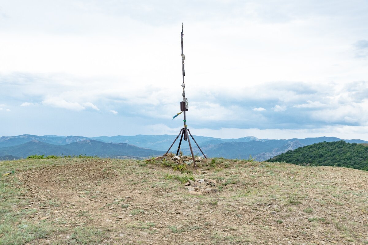 1. Геодезический знак на вершине на фоне гор к северо-западу от Перчема.