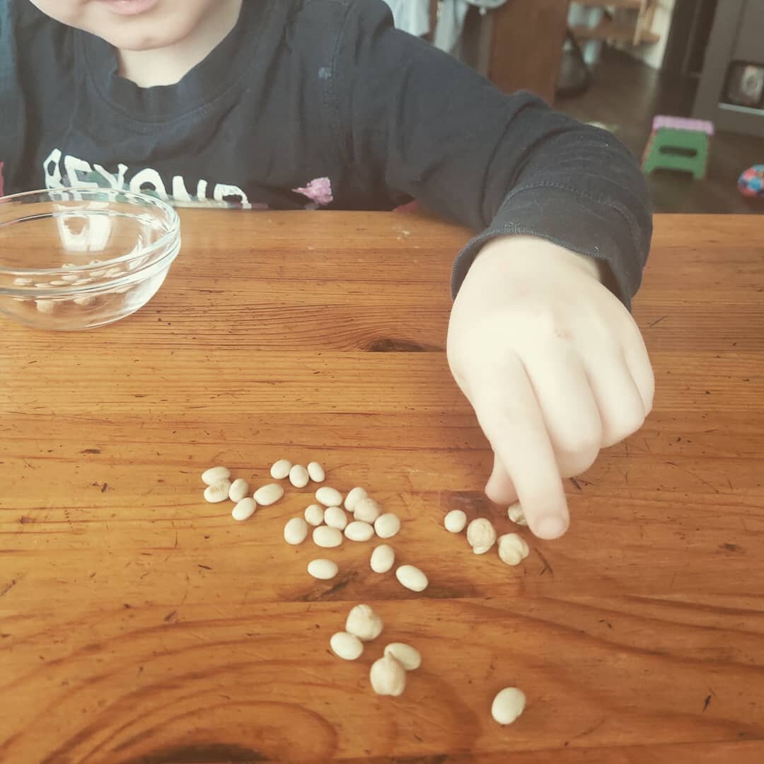 Сортирует фасоль и нут,  эта рука у него парезная. 