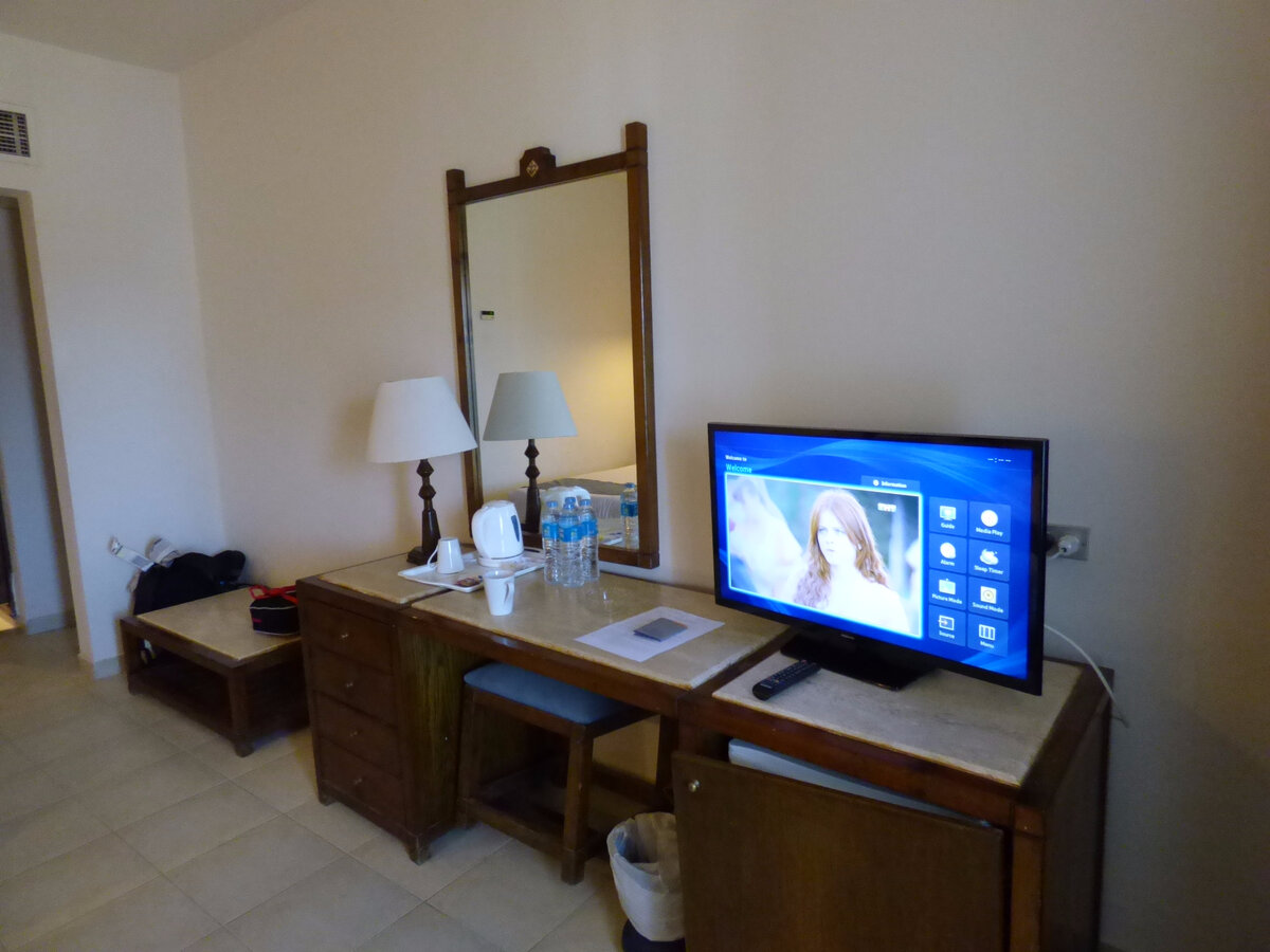 Fig. 2. Egypt, Hurghada, Sunny Days El Palacio Resort & Spa, room 5210 table, lamp, kettle, mirror, TV.