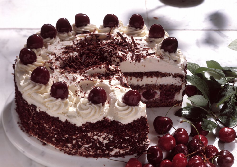 ИНГРЕДИЕНТЫ НА 6   ПОРЦИЙ 
 Изменить состав Единицы измерения
ДЛЯ БИСКВИТА::
Сливочное масло 100 
Темный шоколад 100 
Яйца 3 
Коричневый сахар 80 
Какао-порошок 30 
Миндальная мука 40 
Сода пищевая 0.25 
ДЛЯ КРЕМА::
Темный шоколад 100 
Молочный шоколад 200 
Сливки жирные 150 
Творожный сыр 250 
НАПОЛНЕНИЕ::
Замороженная вишня 250 
Всего:   
Вес состава:	100 гр 
Калорийность
состава:	339 ккал 
Белков:	6 гр
Жиров:	25 гр
Углеводов:	23 гр
 Б/Ж/У:	11 / 46 / 43
 Н17 / С0 / В83
Время приготовления:
 1 д
ПОШАГОВОЕ ПРИГОТОВЛЕНИЕ
ШАГ 1:
Шаг 1.
Как сделать шоколадный торт с вишней? Первым делом необходимо испечь бисквит. Подготовьте для него все необходимое.

ШАГ 2:
Шаг 2.
В чаше для взбивания соедините яйца и коричневый сахар. Взбейте все вместе до пышной, густой пены на максимальной скорости миксера.

ШАГ 3:
Шаг 3.
В небольшом ковше растопите сливочное масло и добавьте к нему поломанный шоколад. Перемешивайте, чтобы шоколад полностью растаял.

ШАГ 4:
Шаг 4.
Отдельно смешайте сухие ингредиенты: миндальную муку, какао и соду. К взбитой яичной массе вмешайте шоколадную и мучную массы. Вмешивайте вручную, с помощью венчика, чтобы тесто оставалось пышное.

ШАГ 5:
Шаг 5.
Шоколадное тесто получается средней густоты.

ШАГ 6:
Шаг 6.
Разъемные формы для выпечки (16 см), застелите пергаментов и испеките 3 отдельных коржа в предварительно разогретой духовке, при 180 градусах, в течение 15 минут. Ориентируйтесь по своей духовке.

ШАГ 7:
Шаг 7.
Затем их остудите, сложите друг на друга вместе с бумагой и оберните пищевой пленкой. Уберите в холодильник на ночь, чтобы они отлежались. Для сборки торта бисквиты отделите друг от друга и снимите с них пергамент.

ШАГ 8:
Шаг 8.
Для приготовления шоколадного крем-чиза подготовьте необходимые ингредиенты.

ШАГ 9:
Шаг 9.
Для наполнения будем использовать вишню. Замороженные ягоды необходимо разморозить. Сок от ягод слейте в отдельную чашу, а потом пропитайте им бисквиты.

ШАГ 10:
Шаг 10.
Для крема нагрейте сливки до горячего состояния и добавьте к ним поломанный шоколад. Размешивайте до однородного состояния. Шоколад быстро растает. Готовую шоколадную массу остудите до комнатного состояния.

ШАГ 11:
Шаг 11.
Соедините шоколадную массу и творожный сыр.

ШАГ 12:
Шаг 12.
Все смешайте миксером до однородности. Готовый крем будет достаточно стабильный. Этого количества хватает для сборки торта диаметром 16 см, чернового и финального выравнивания.

ШАГ 13:
Шаг 13.
Промажьте бисквиты шоколадным кремом и выложите ягоды вишни.

ШАГ 14:
Шаг 14.
Соберите торт. Обмажьте его со всех сторон тонким слоем шоколадного крема. Это будет черновое выравнивание. Оно запечает в себе все лишние крошки. Уберите торт в холодильник для застывания на несколько часов.

ШАГ 15:
Шаг 15.
Застывший торт ещё раз обмажьте шоколадным кремом и выровняйте. Торт готов! Украсить его каждый может по своему вкусу. Я сделала на торте шоколадные подтеки и украсила фруктами.

ШАГ 16:
Шаг 16.
Торт получается вкусный, сытный и мега шоколадный. Приятного угощения!