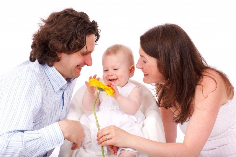 https://visualhunt.com/photo4/10907/portrait-of-happy-family-with-baby-daughter-playing-with-flower/