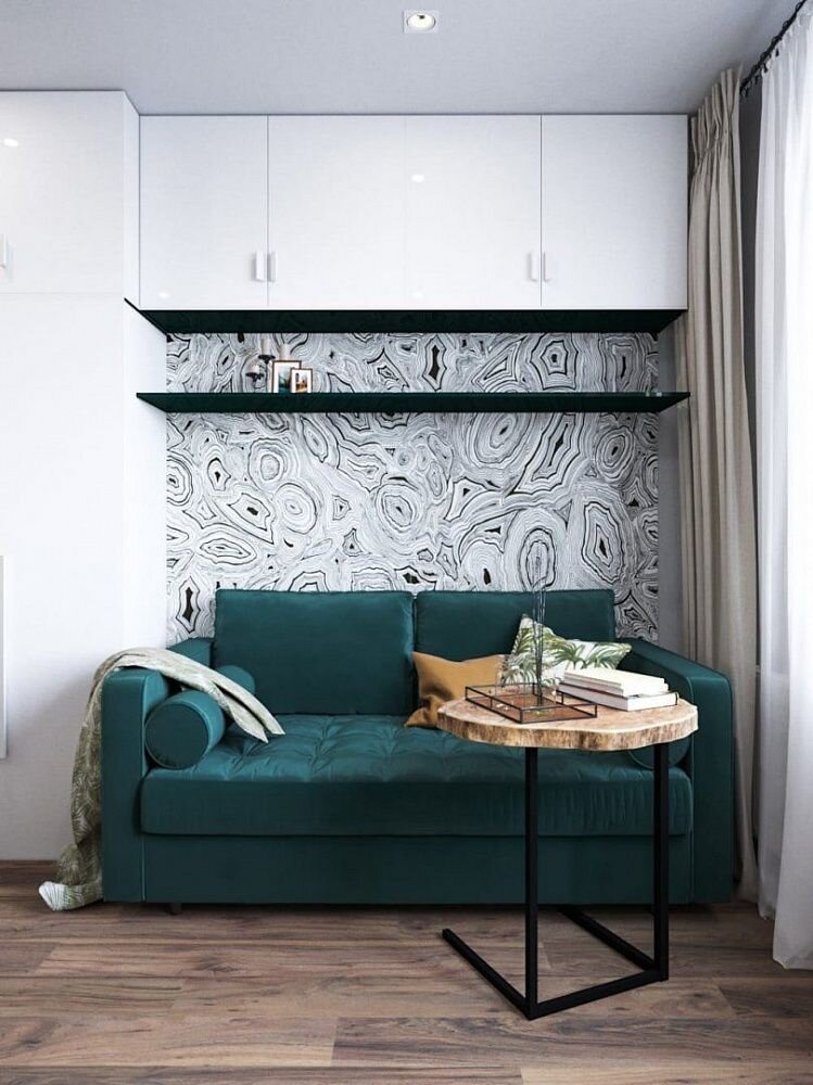 Этот скандинавский интерьер квартиры-студии площадью 23 м², созданный дизайнерами студии VizDiz, очень эстетичен. Несмотря на достаточно простую отделку, интерьер в целом смотрится интересно. Красивые напольные покрытия, черные графичные акценты и изумрудный диван в качестве главного цветового акцента создают красивую стильную композицию.