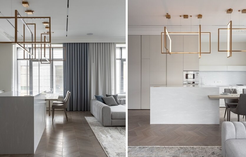 Одним из пожеланий хозяйки была большая гостиная, объединенная с кухней. Дизайнер предложила кухонную часть сделать максимально невидимой, спрятать все за минималистичными фасадами мебели в тон стен. А объединяющую часть в виде острова, который выглядит цельным каменным блоком с интегрированным в него обеденным столом, наоборот, выделить. Акцентом этой композиции стали люстры Frame испанского бренда Aromas Del Campo. Получилась очень красивая композиция, создающая эффектный объем и задающая динамику из золотых линий на спокойном фоне фасадов.