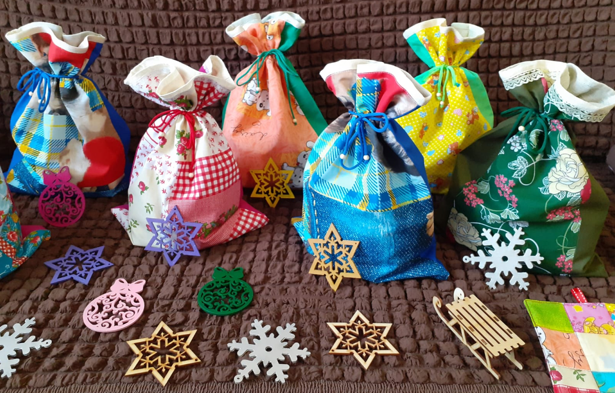 На фото мешочки для подарков в лоскутной технике с деревянными игрушками Ярыгина Михаила. Фото игрушек предоставлено с разрешения Михаила.