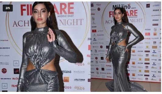 Нора Фатехи, известная своими танцевальными номерами, пришла на мероприятие в серебряном платье. (Вариндер Чавла)