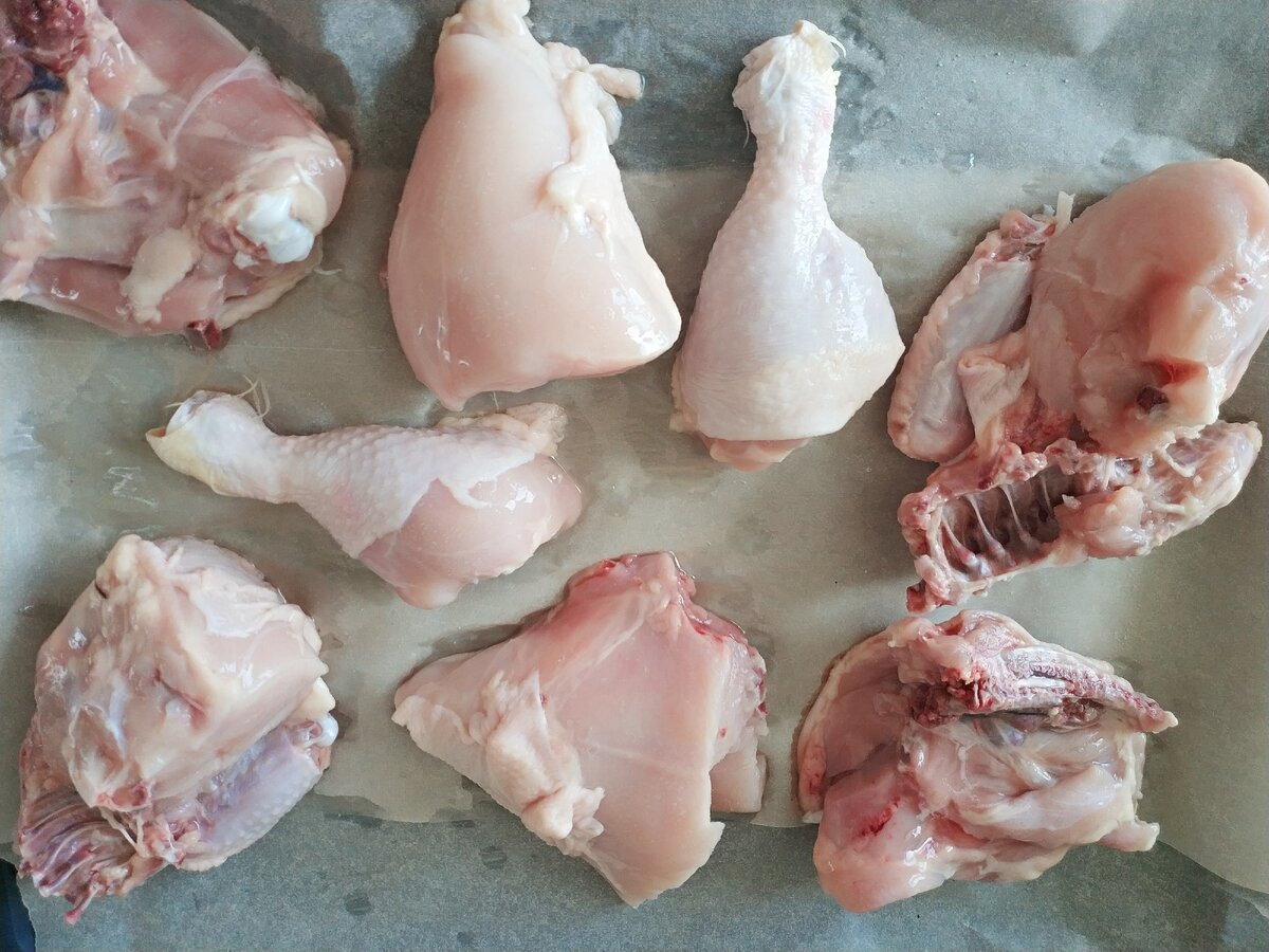 Шаг 2. На пергаметную бумагу выкладываем кусочки курочки.