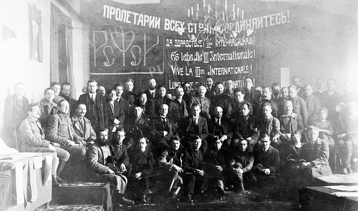 В.И. Ленин  в группе делегатов I конгресса Коминтерна в Кремле. На снимке также: Уншлихт И.С., Троцкий Л.Д., Зиновьев Г.Е., Бухарин Н.И., Каменев Л.Б., и др. Фотограф Я.В. Штейнберг Я.В.  Коммунистический интернационал (Коминтерн, Коммунистический интернационал. или III Интернационал) был образован в 1919 году и объединил коммунистические партии разных стран. Цель -  "союз рабочих всего мира, стремящихся к установлению Советской власти во всех странах" (сформулировал Ленин). Организация просуществовала до 1943 года,Бухарин возглавлял Коминтерн в 1926-1929 гг.