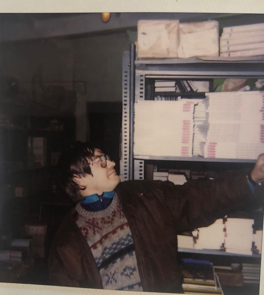 Станислав Гаврилов (Слава Кемерово) позирует на фоне наших стеллажей. На полке, возможно, детские энциклопедии от издательства "СЛОВО/SLOVO"