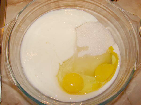 в миску вбиваю яйца,добавляю кефир,молоко,соль,сахар,разрыхлитель,растопленное сливочное масло,муку и немного крахмала,хорошо все перемешиваю миксером.