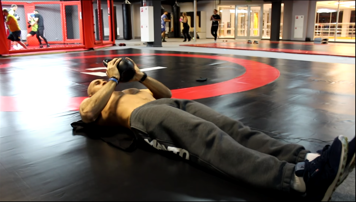 Первое упражнение для прокачивания пресса с гирей. Кадры из видео с канала Papa Smith