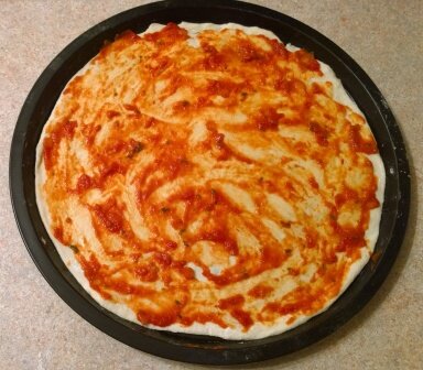 Основа пиццы с добавленным соусом