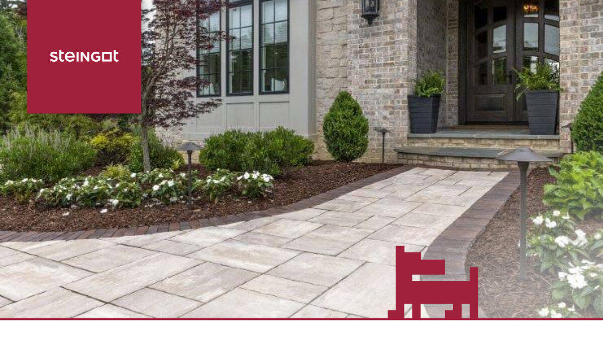 Нежно-бежевая тротуарная плитка из коллекции Colormix, окантованная камнями более темного оттенка, гармонирует с фасадом дома, декоративными элементами и озеленением. Такой дизайн в целом создает ощущение надежности и стабильности.