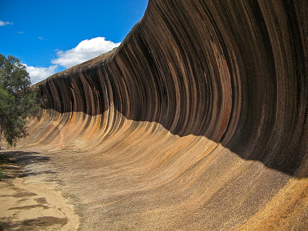 Цветные полосы на склоне каменной волны появились благодаря дождевой воде, смывающей карбонаты и гидроксид железа из выветрелого гранита.