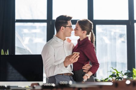 https://st3.depositphotos.com/12039478/18474/i/450/depositphotos_184747874-stock-photo-attractive-kissing-young-businesspeople-formal.jpg