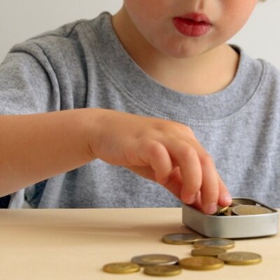    Children with Saving Money for Education Concept. 2 Years Old Child putting Coin into a Box Валерий