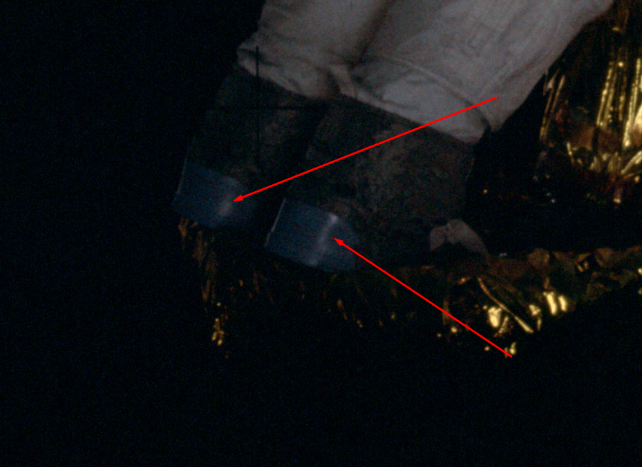 На лунных ботинках астронавта,пусть он  будет астронавтом,мы видим 
какие-то "естественные" яркие блики.
Нам говорят,что это солнечный свет отражённый от грунта и скафандра фотографа
снимающего выход напарника.
Оу кей,как говорят сами американцы,да будет так.