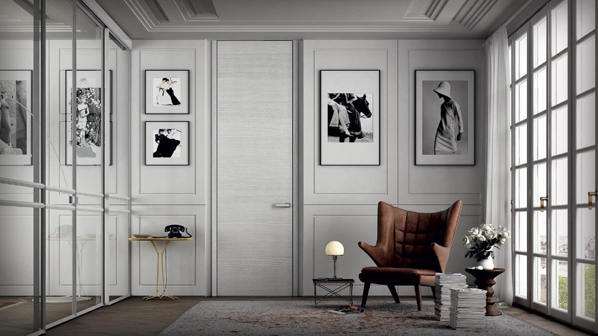 Лаконичный вариант оформления двери высотой в потолок под цвет стен