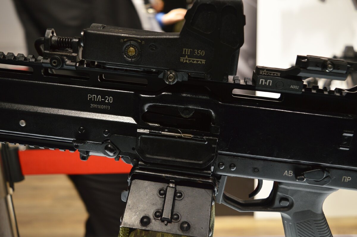 Совсем недавно на форуме Армия 2020 был представлен новый образец вооружения от Концерна Калашников (КК) под названием РПЛ-20, что расшифровывается как Ручной Пулемет с Ленточным питанием обр. 20 года. Его появление на выставке вызвало не малый ажиотаж. Действительно ручных пулеметов с ленточным питанием под патрон 5,45х39 в современной России практически не создавалось. Есть исключение в виде ручного пулемета по теме “Токарь”, но на вооружение он до сего момента не принимался (проходит гос. испытания). Как альтернатива ему, и как чисто армейский вариант ручного пулемета с ленточным питанием под промежуточный патрон 5,45 и создавался РПЛ-20.
 
Выглядит опытный образец довольно интересно, и если к его внешнему виду больших вопросов нет, то внутреннее устройство пулемета интригует. Еще до поездки на форум, мне показались знакомыми некоторые элементы его конструкции, но поспешных выводов я делать не стал. Однако после осмотра РПЛ-20 на стенде КК, большинство моих догадок подтвердились. 
 
И так, внутреннее устройство пулемета: 
Газовый двигатель (БГД) располагается классически над стволом. Автоматика построена на использовании длинного хода газового поршня. Стрельба производится с заднего шептала. Запирание канала ствола поворотом затвора. Расположение механизма подачи ленты снизу относительно ствола. На правой стороне ствольной коробки (СК) над окном лентоприемника мы видим нечто похожее на защитный корпус. Как оказалось, весь лентоподающий механизм и блок автоматики выполнен по образу и подобию Пулемета Калашникова (ПК), только перевернутого на 180⁰. Приглядитесь и увидите много схожего. Досылание патрона из ленты в патронник прямое. Про спусковой механизм что-то сказать трудно, но он так же мог быть заимствован у ПК. Очевидно, что базой для разработки РПЛ-20 стал старый добрый Пулемет Калашникова. Это то, что можно сказать наиболее точно. По моим личным измышлениям конструкторы могли так же оснастить пулемет буфером отдачи для торможения затворной рамы. Сменные стволы, различной длинны, уже были показаны. Общая масса в 5,2-5,5 кг – очень неплохой показатель для пулеметов этого класса. В процессе доводки конструкции он может и потяжелеть. О надежности работы пулемета пока ничего не известно. Но по моему мнению нижнее расположение механизма подачи ленты как минимум не самое лучшее решение. 

В общем и целом, пулемет как новинка довольно интересен, но внутри ничего особенного из себя не представляет и использует уже имеющиеся наработки по другим изделиям. В том числе наработки по созданию лент под патрон 5,45. Такие ленты были разработаны для опытного ПУ-2 (ПУ-21), а потому фраза: «ленты для 5,45 не существовало» не совсем правдива. Кто-то видит в РПЛ-20 схожесть с FN minimi, кто-то с Токарь 2, но больше всего он похож именно на ПК, да еще и перенял от него многие конструктивные решение. 
