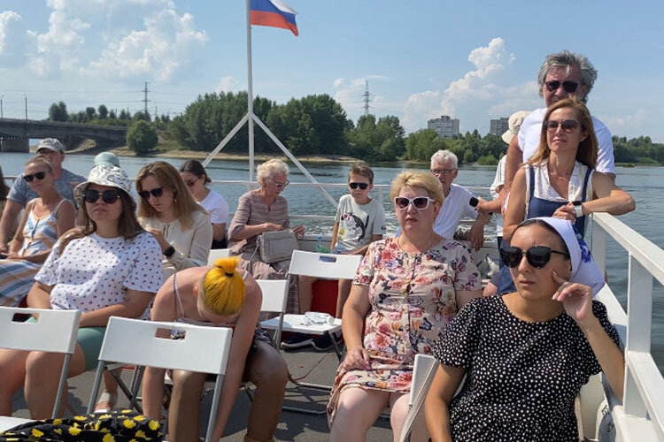 На открытой палубе теплохода стоит несколько рядов пластмассовых стульчиков. Внизу, под крышей, подволок действительно низковат: высоким людям приходится нагибаться, чтобы пройти по нижней палубе. Фото: Валерия Купцова