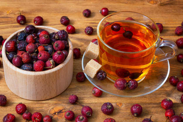 https://image.freepik.com/free-photo/flatly-dried-rosehip-berries-with-a-cup-of-aromatic-rosehip-drink-on-a-wooden-healing-berries_165541-20.jpg