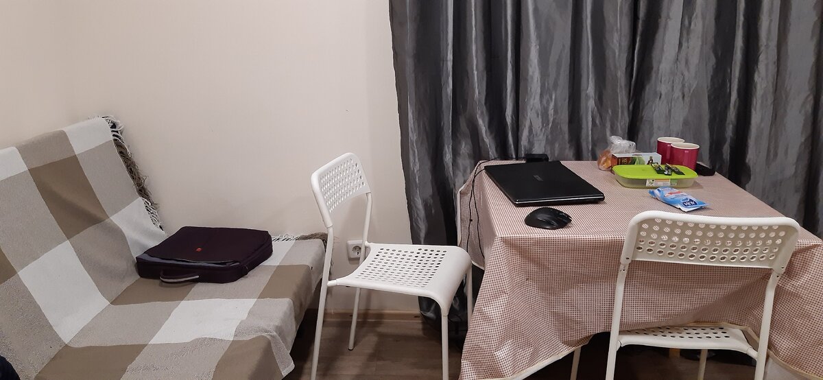 За спиной входная дверь. Справа кровать, кухонный уголок и дверь в санузел.