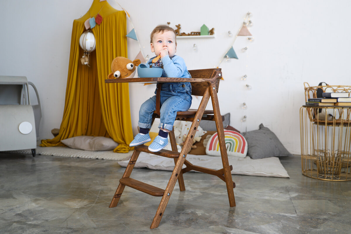 Складной растущий стул Klapp Kids с разложенным столиком.